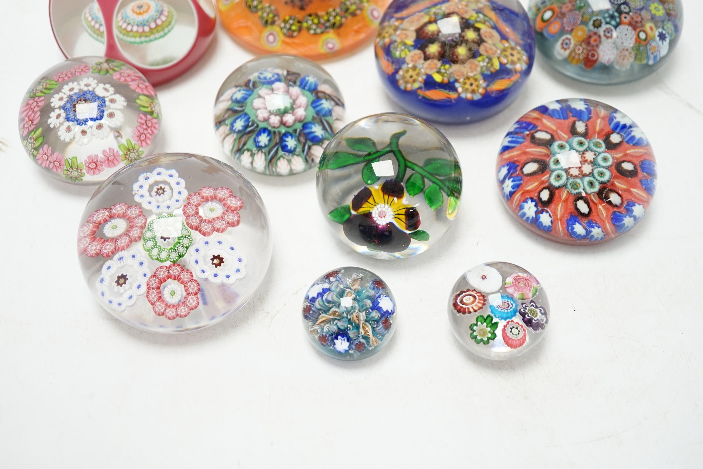 A collection of eleven glass paperweights, largest 10cm high. Condition - good